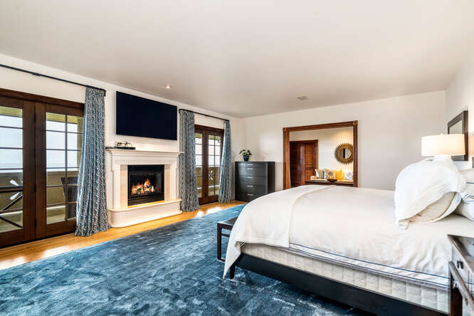 28-3628 Hawaiʻi Belt Road Honomu, HI 96728 - Photo 24 of 30 a bedroom with a bed and a fireplace