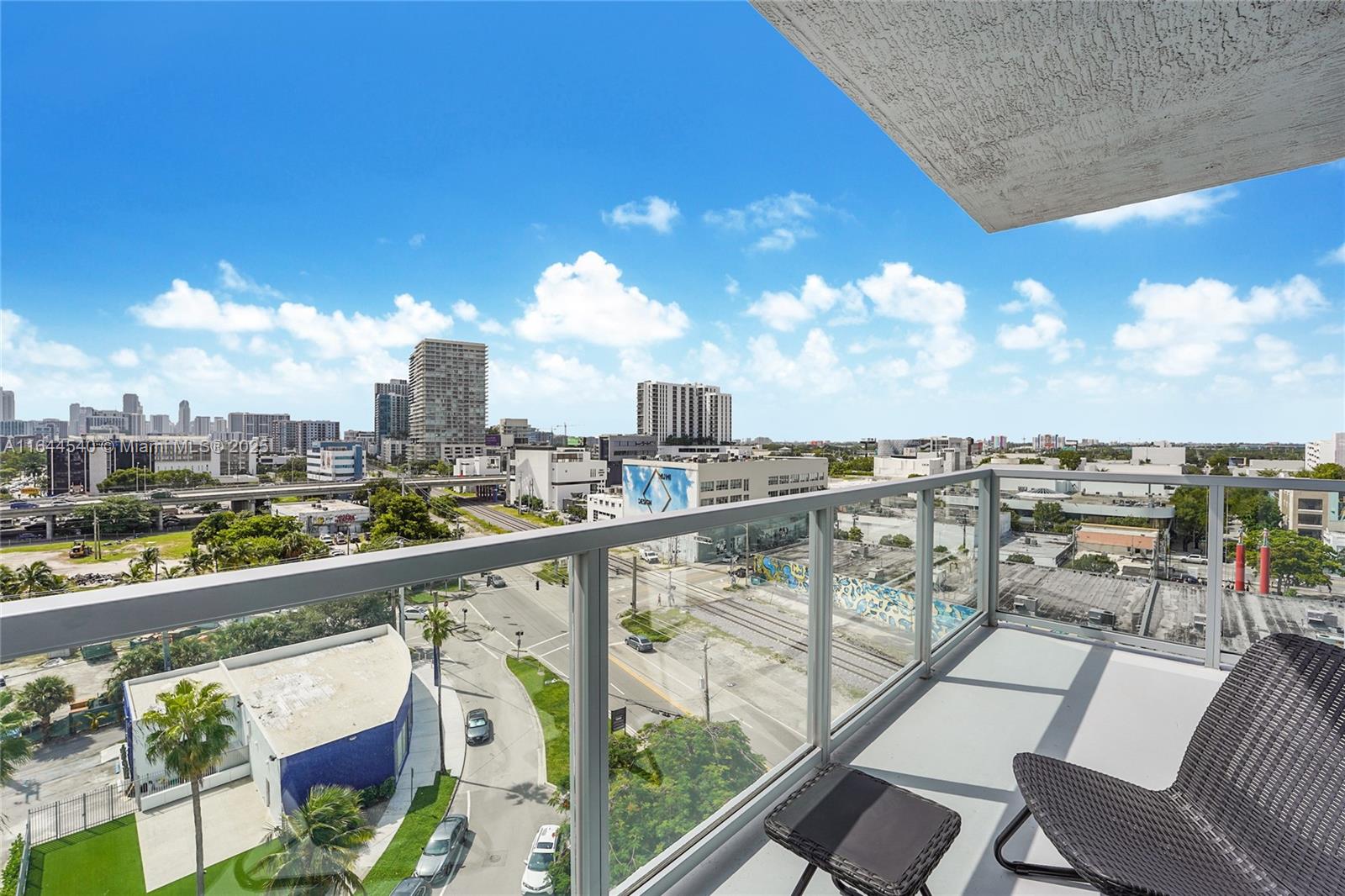 3900 Biscayne Boulevard, Unit S702 Miami, FL 33137 - Photo 11 of 12 a view of a city from a balcony with furniture