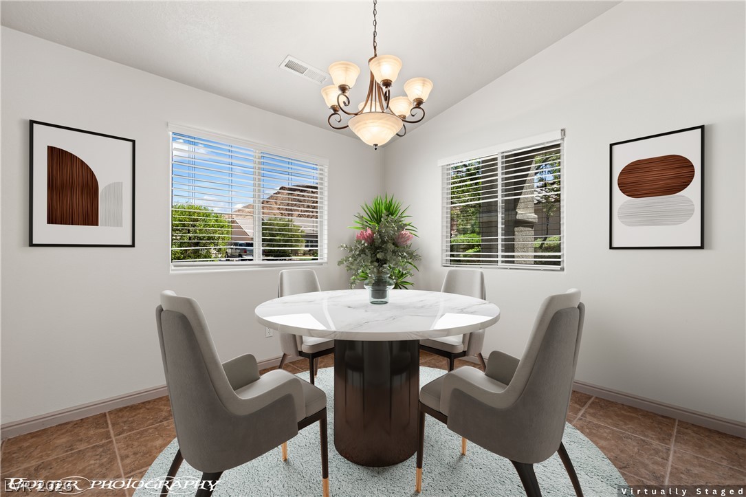 874 Glendale Road Mesquite, NV 89027 - Photo 30 of 71 A refined dining space features a vaulted ceiling and elegant tile flooring, perfect for intimate gatherings.