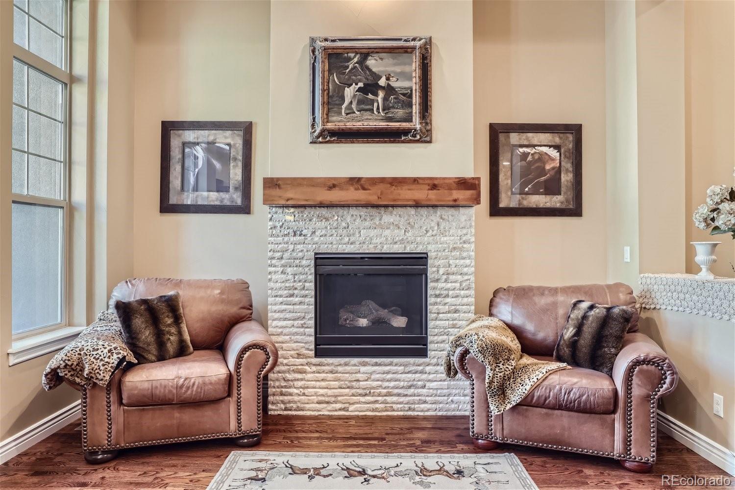 10104 Inverness Main Street Englewood, CO 80112 - Photo 13 of 34 a living room with furniture and a fireplace