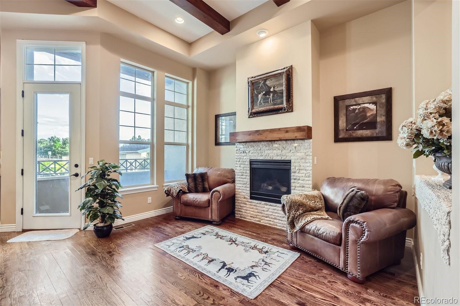10104 Inverness Main Street Englewood, CO 80112 - Photo 14 of 34 a living room with furniture windows and a fireplace