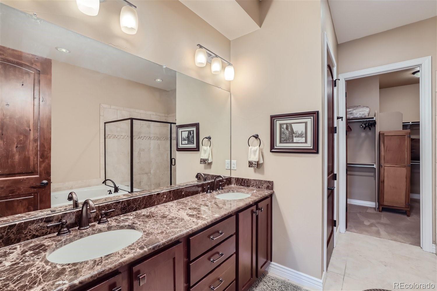10104 Inverness Main Street Englewood, CO 80112 - Photo 21 of 34 a bathroom with a granite countertop sink and a mirror