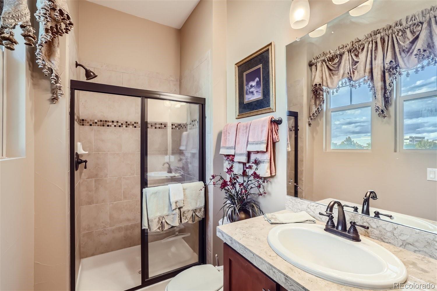 10104 Inverness Main Street Englewood, CO 80112 - Photo 26 of 34 a bathroom with a sink and a mirror