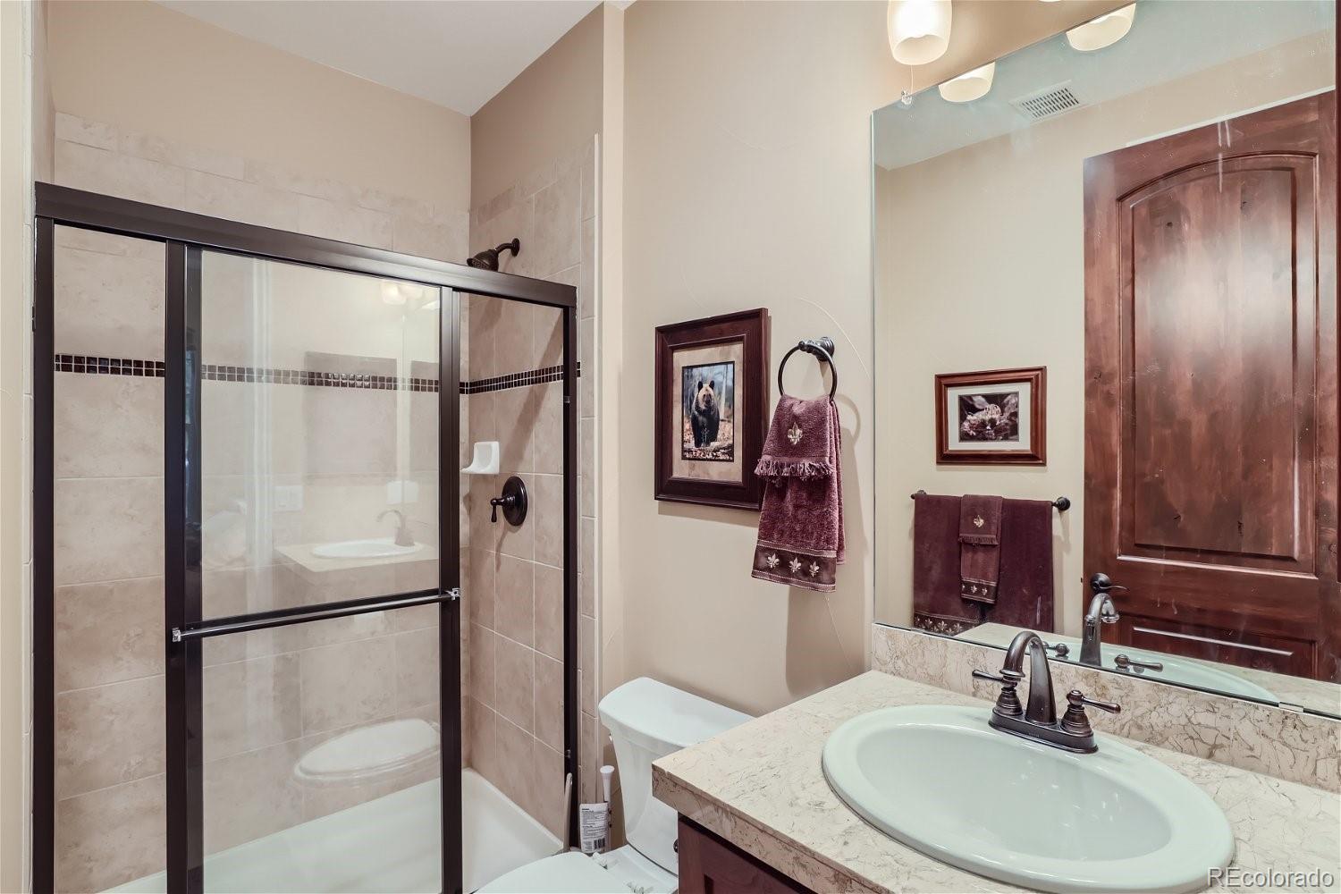 10104 Inverness Main Street Englewood, CO 80112 - Photo 5 of 34 a bathroom with a sink toilet and shower