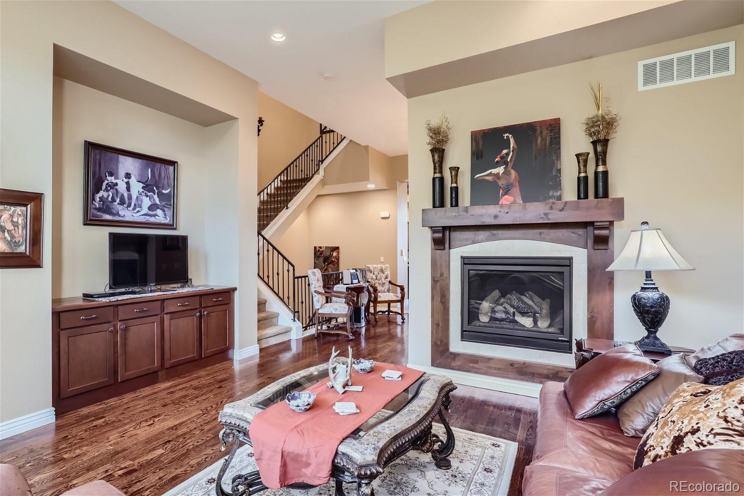 10104 Inverness Main Street Englewood, CO 80112 - Photo 8 of 34 a living room with furniture and a fireplace