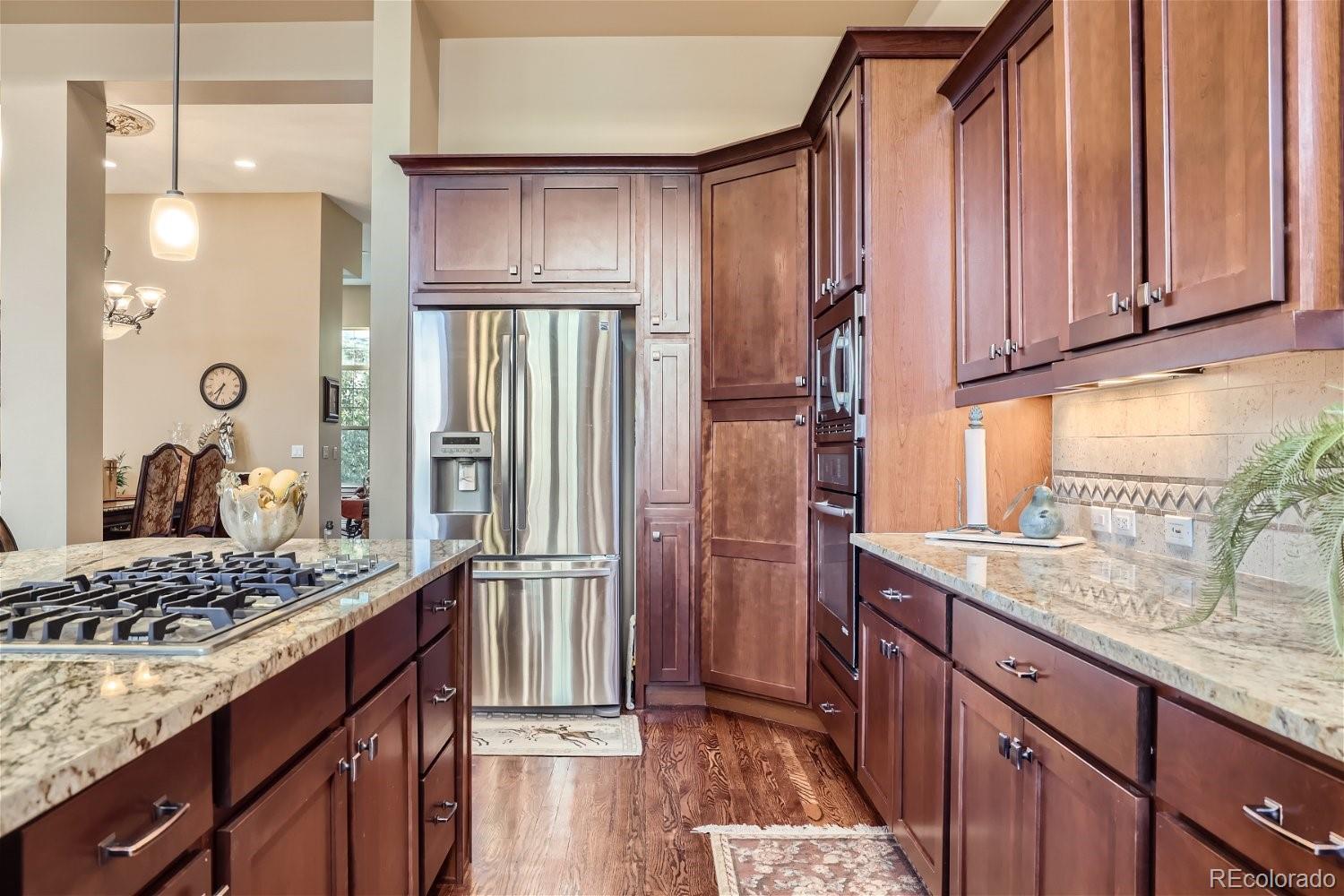 10104 Inverness Main Street Englewood, CO 80112 - Photo 10 of 34 a kitchen with stainless steel appliances granite countertop a refrigerator and a stove