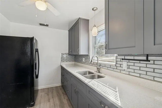 a kitchen with a sink stove top oven and cabinets