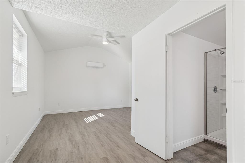 2900 49th Street North St. Petersburg, FL 33710 - Photo 15 of 52 an empty room with wooden floor and a window