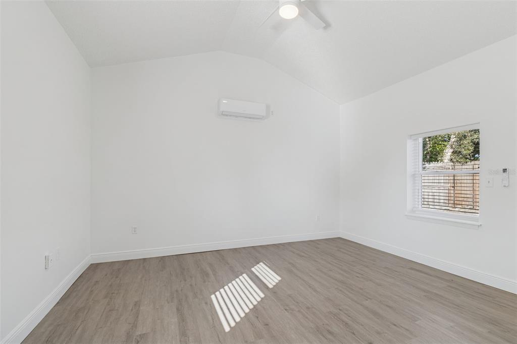 2900 49th Street North St. Petersburg, FL 33710 - Photo 16 of 52 an empty room with wooden floor and windows
