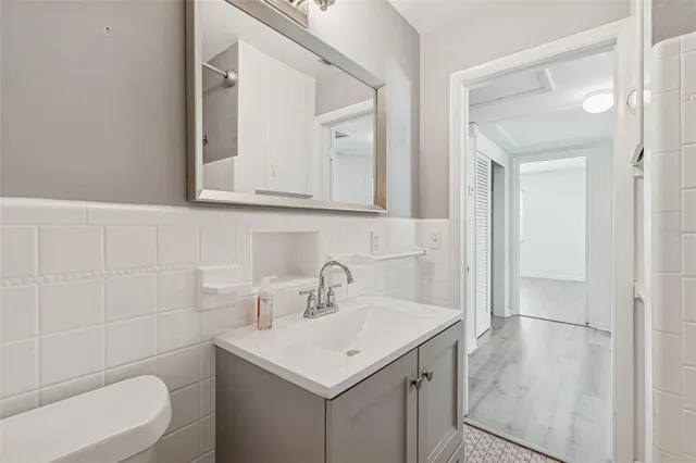 an empty room with wooden floor and ceiling fan