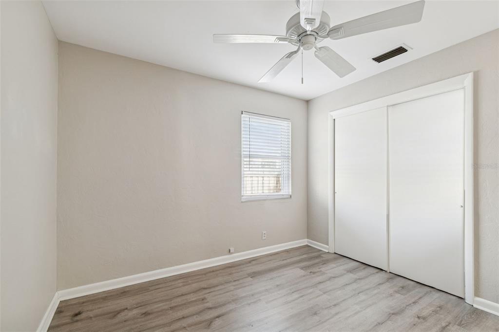 2900 49th Street North St. Petersburg, FL 33710 - Photo 32 of 52 an empty room with windows and fan