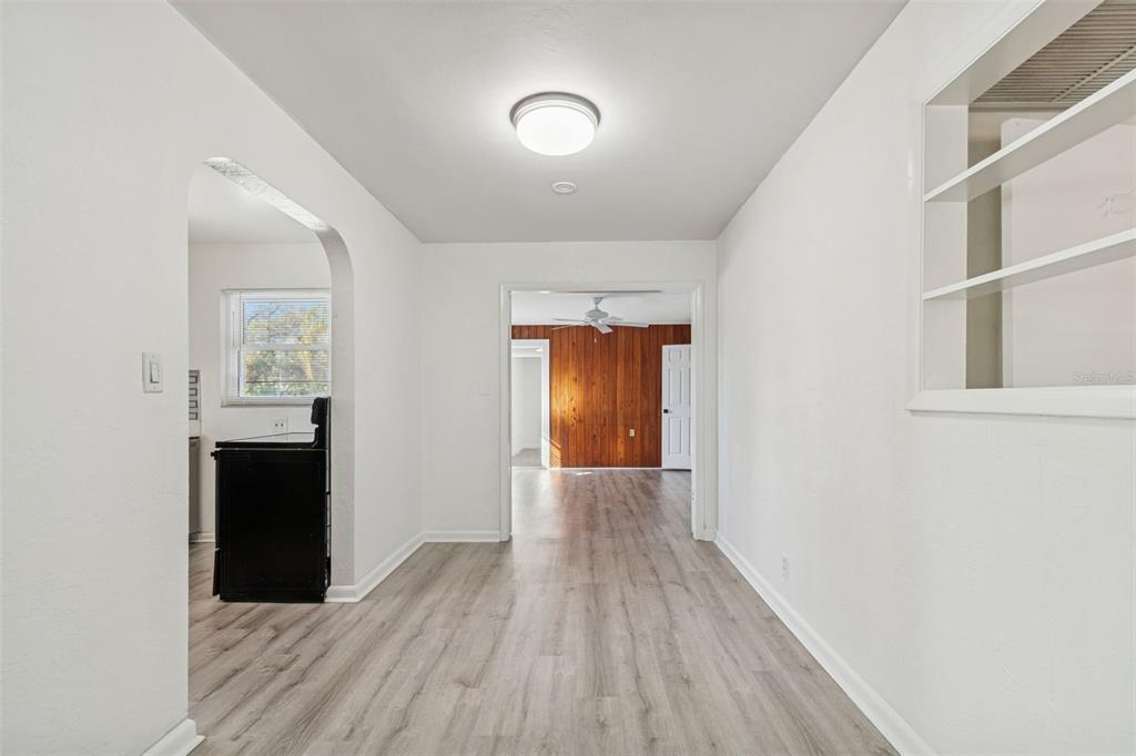 2900 49th Street North St. Petersburg, FL 33710 - Photo 7 of 52 a view of a hallway with wooden floor and a bathroom