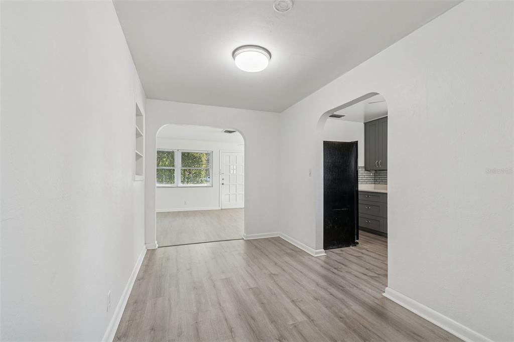 2900 49th Street North St. Petersburg, FL 33710 - Photo 8 of 52 an empty room with wooden floor and windows