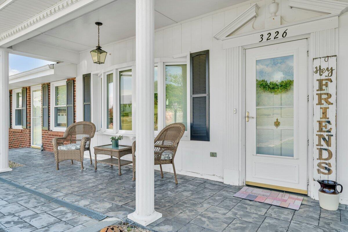 3226 Rakes Road Rocky Mount, VA 24151 - Photo 4 of 74 a dining room with wooden floor and a chandelier