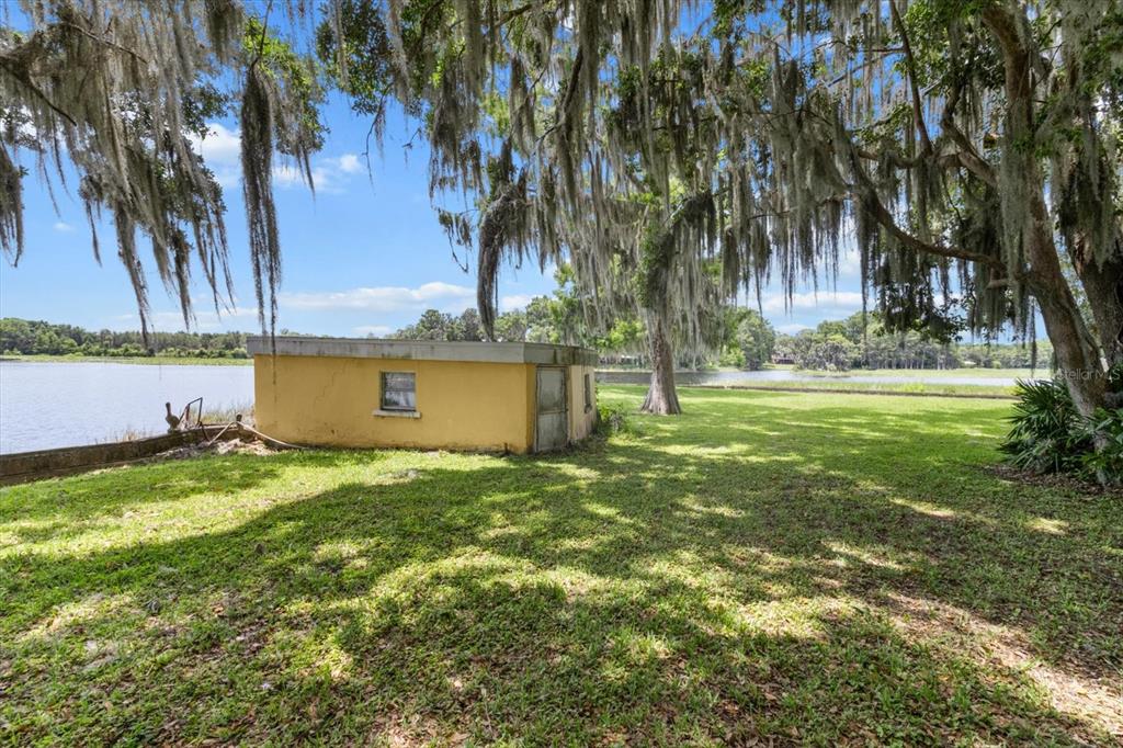 1226 South Telephone Point Road Inverness, FL 34450 - Photo 15 of 43 a view of a yard with a house and large trees