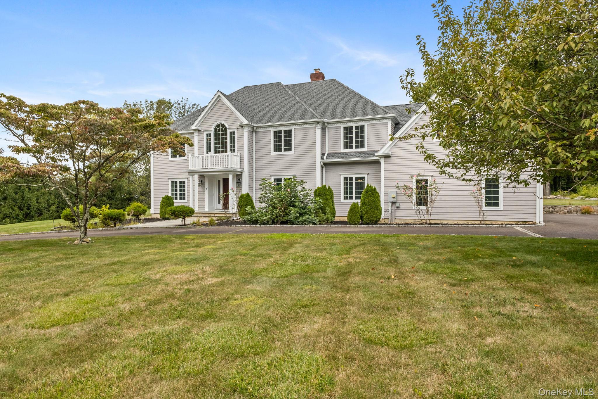 49 Ludlowe Road New Canaan, CT 06840 - Photo 1 of 1 View of front of house with a shingled roof, a front lawn, and a chimney