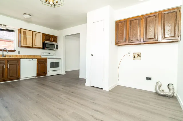 a kitchen with stainless steel appliances a stove top oven a sink and a microwave