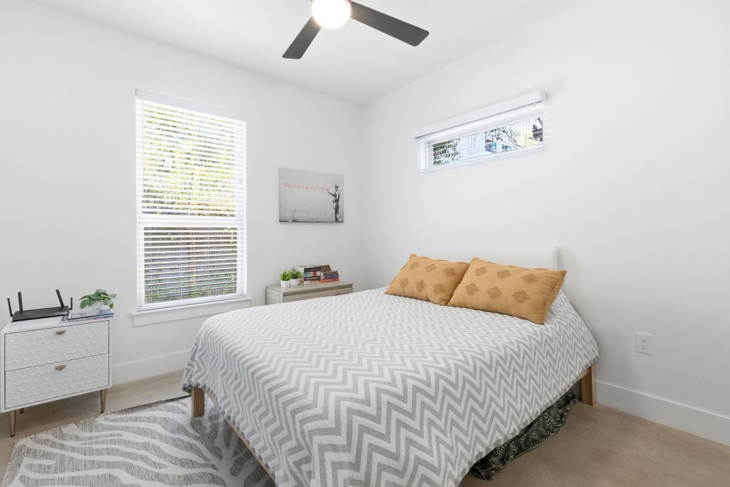 3112 Powell Circle Austin, TX 78704 - Photo 9 of 27 Bedroom featuring baseboards and a ceiling fan