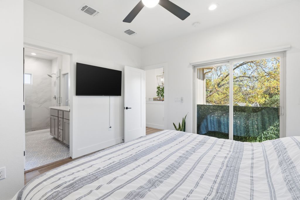 3112 Powell Circle Austin, TX 78704 - Photo 16 of 27 Bedroom featuring ceiling fan, recessed lighting, ensuite bathroom, and access to exterior