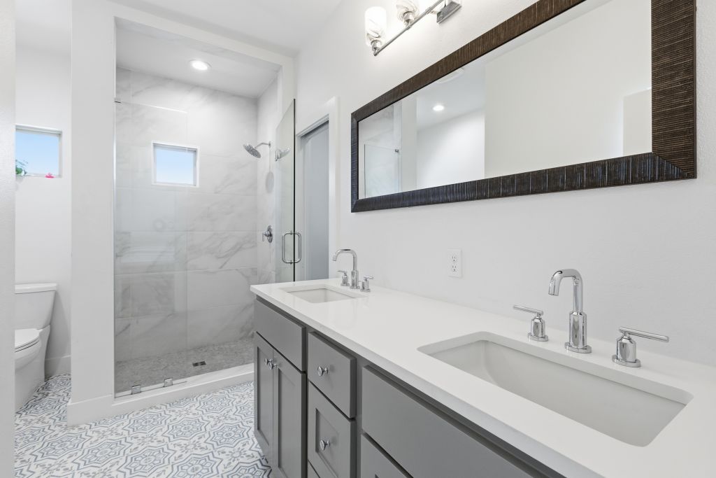 3112 Powell Circle Austin, TX 78704 - Photo 17 of 27 Full bath featuring double vanity, a shower stall, and recessed lighting