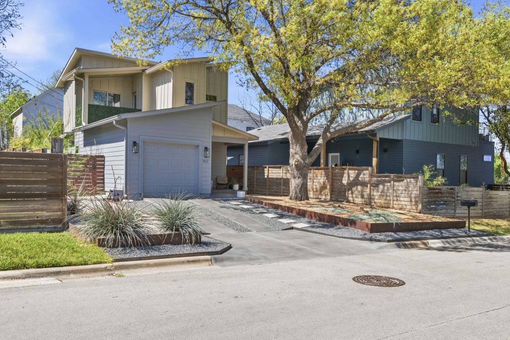 3112 Powell Circle Austin, TX 78704 - Photo 2 of 27 View of front of house with driveway, a garage, and board and batten siding