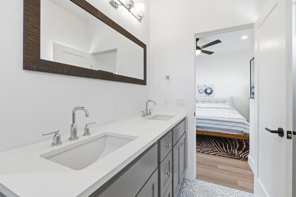 3112 Powell Circle Austin, TX 78704 - Photo 20 of 27 Ensuite bathroom with double vanity, light wood finished floors, recessed lighting, and ceiling fan