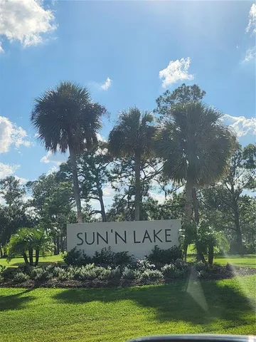 a view of a fountain in front of a house with a yard