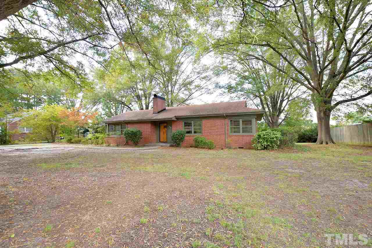 313 Loop Road Garner, NC 27529 - Photo 2 of 12 a big room with trees in front of it