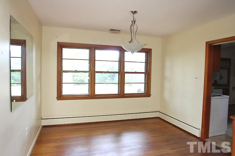 313 Loop Road Garner, NC 27529 - Photo 6 of 12 a view of an empty room with wooden floor and a window