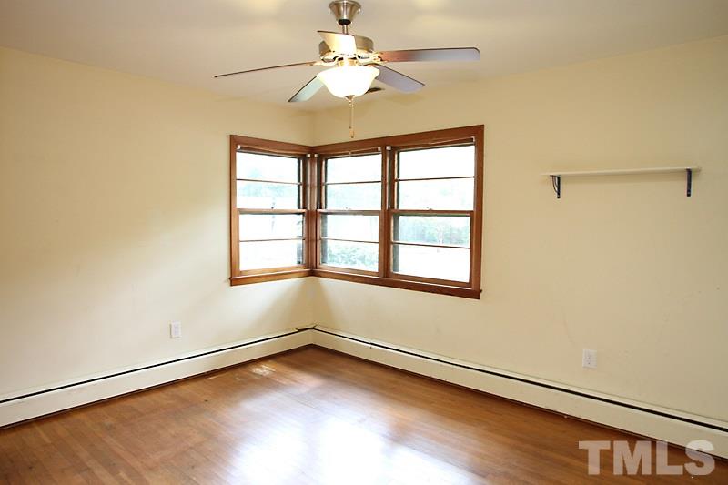 313 Loop Road Garner, NC 27529 - Photo 8 of 12 wooden floor in an empty room with a window