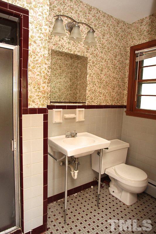 313 Loop Road Garner, NC 27529 - Photo 10 of 12 a bathroom with a sink toilet and mirror