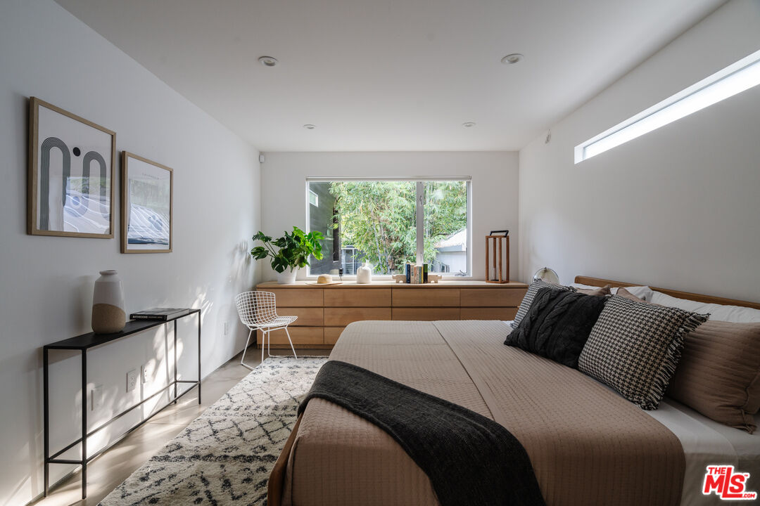 8570 Rugby Drive West Hollywood, CA 90069 - Photo 12 of 35 a bedroom with a large bed and a window