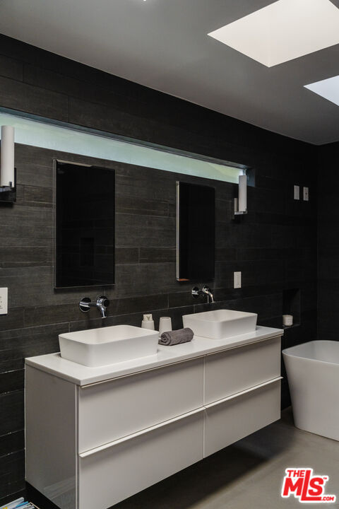 8570 Rugby Drive West Hollywood, CA 90069 - Photo 13 of 35 a bathroom with a double vanity sink and a mirror