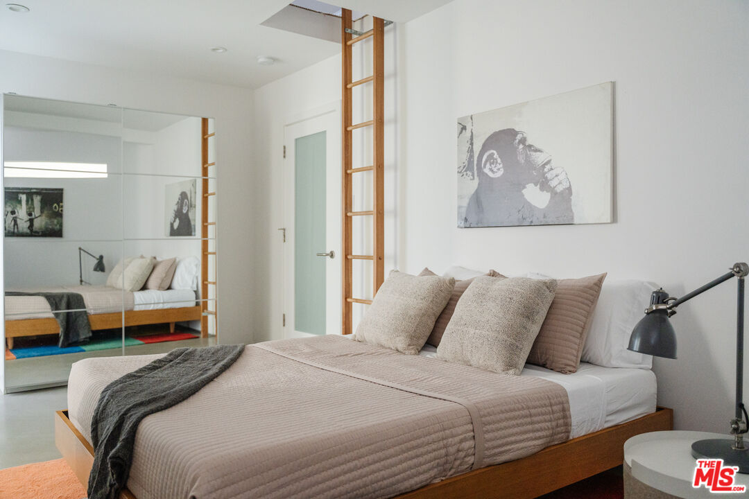 8570 Rugby Drive West Hollywood, CA 90069 - Photo 16 of 35 a bedroom with a bed and a painting on the wall