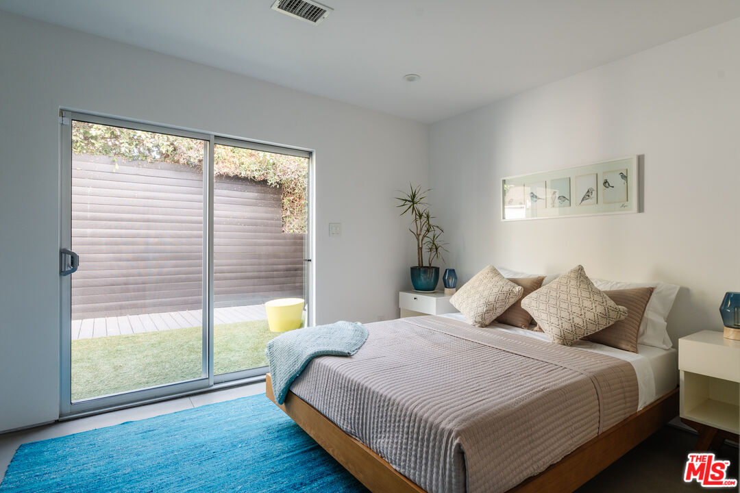 8570 Rugby Drive West Hollywood, CA 90069 - Photo 21 of 35 a bedroom with a bed and a large window