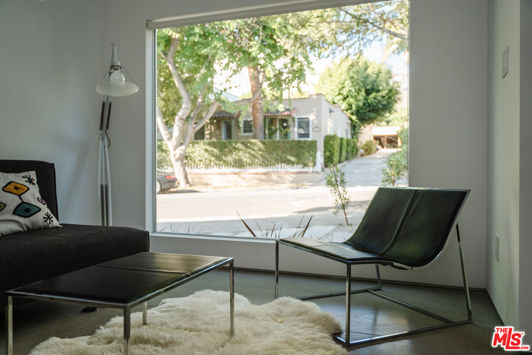 8570 Rugby Drive West Hollywood, CA 90069 - Photo 24 of 35 a living room with a floor to ceiling window and wooden floor