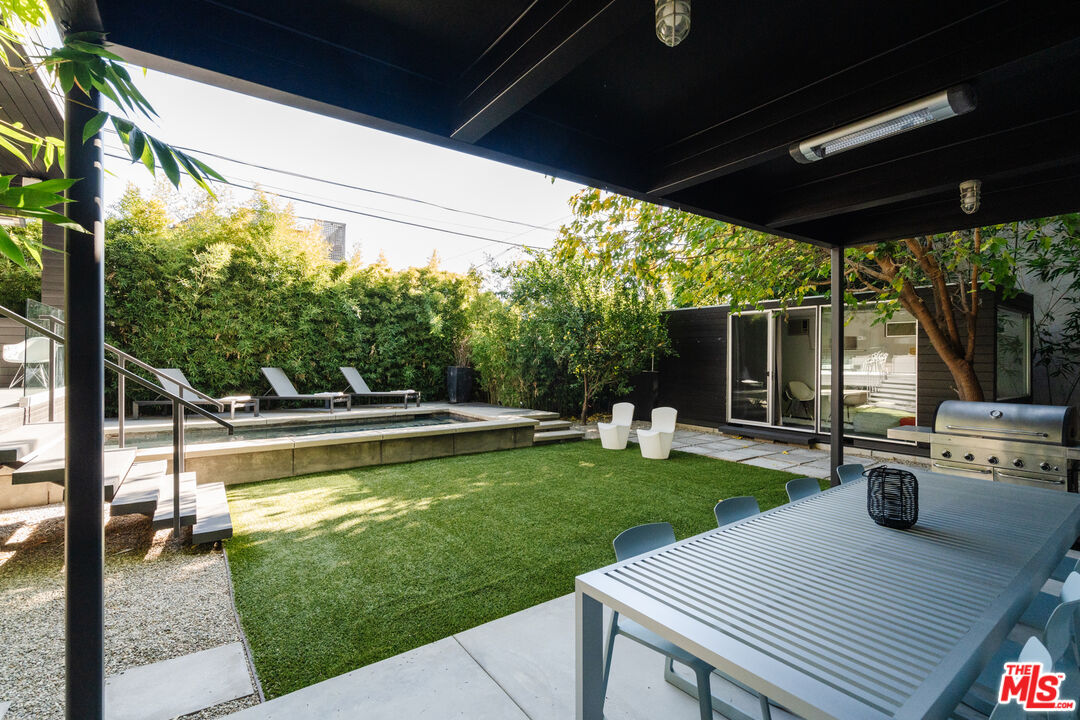 8570 Rugby Drive West Hollywood, CA 90069 - Photo 28 of 35 a view of a patio with table and chairs potted plants with wooden floor and floor to ceiling window