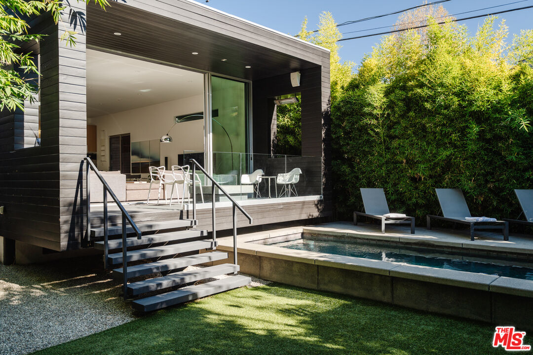 8570 Rugby Drive West Hollywood, CA 90069 - Photo 34 of 35 a view of pool with lawn chairs and couches
