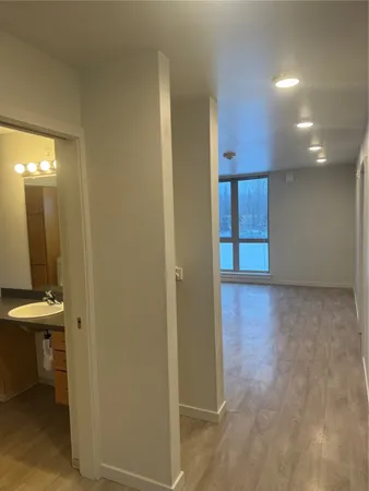 a view of a hallway with wooden shelves