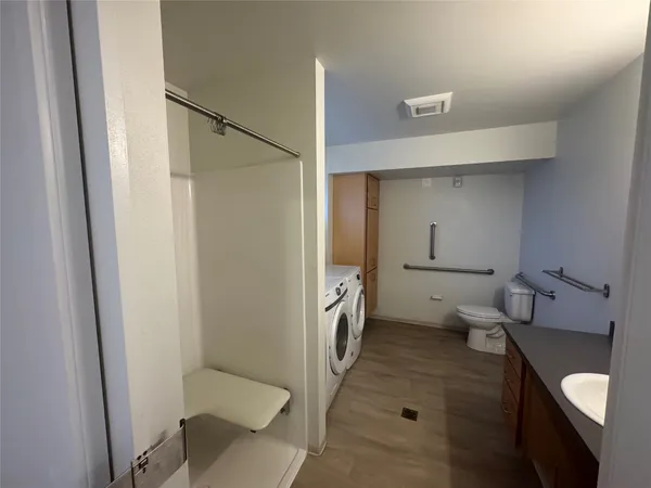 a bathroom with a toilet and a shower