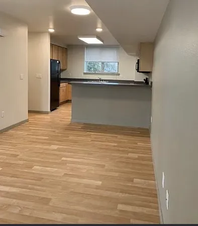 a view of kitchen and kitchen with stainless steel appliances