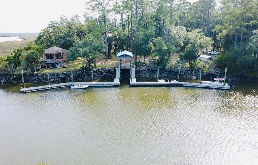 1525 Black Island Road Darien, GA 31305 - Photo 34 of 41 a view of a swimming pool with a bench and trees in the background