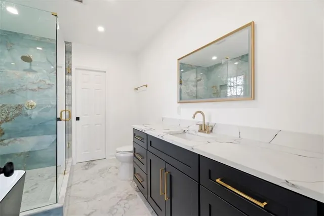a bathroom with a granite countertop sink mirror and double