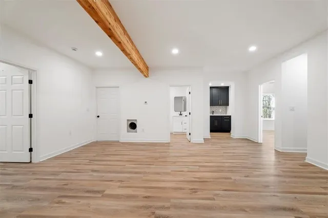 a view of empty room with wooden floor