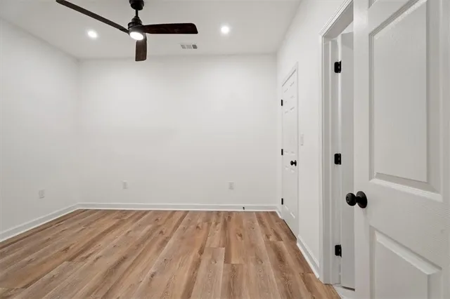 a view of a room with wooden floor