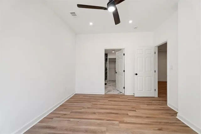 a view of a room with wooden floor