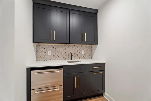 a kitchen with a sink and cabinets