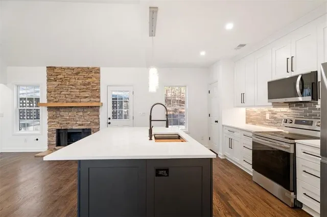 a kitchen with a stove and a kitchen island