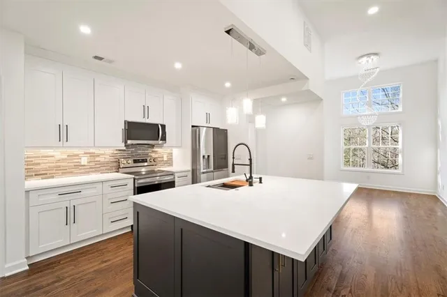 a kitchen with sink a stove and refrigerator