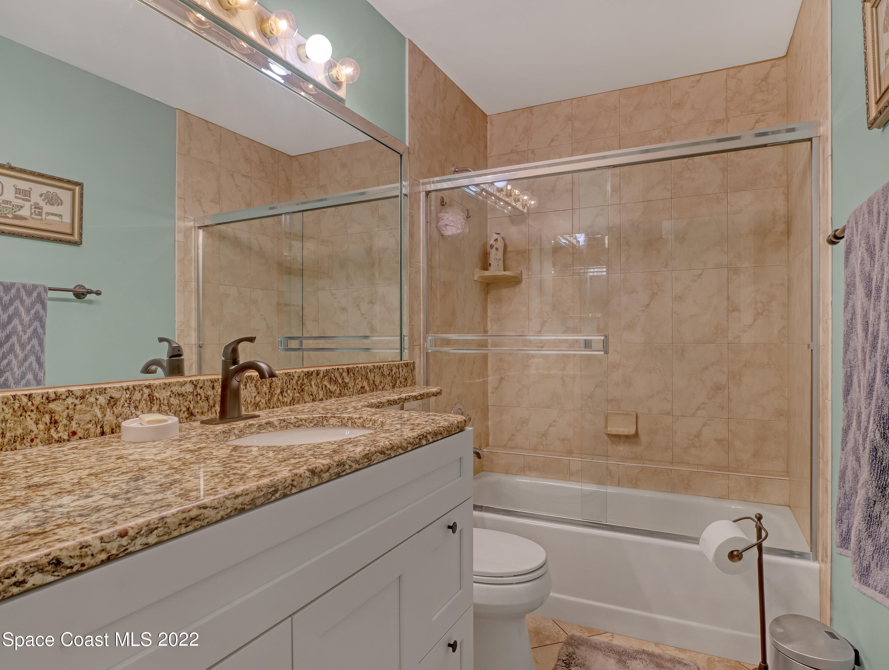 409 Rheine Road Northwest Palm Bay, FL 32907 - Photo 23 of 33 a bathroom with a granite countertop sink toilet and shower